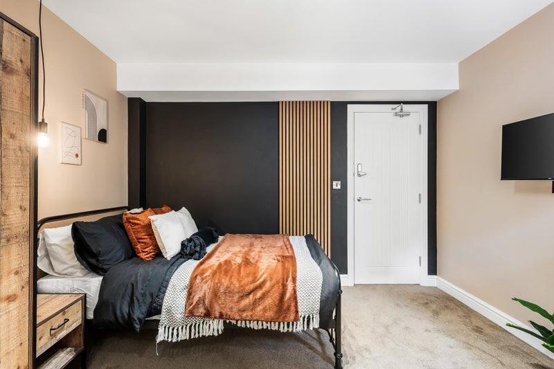 A stylish and cozy double bedroom featuring a c...