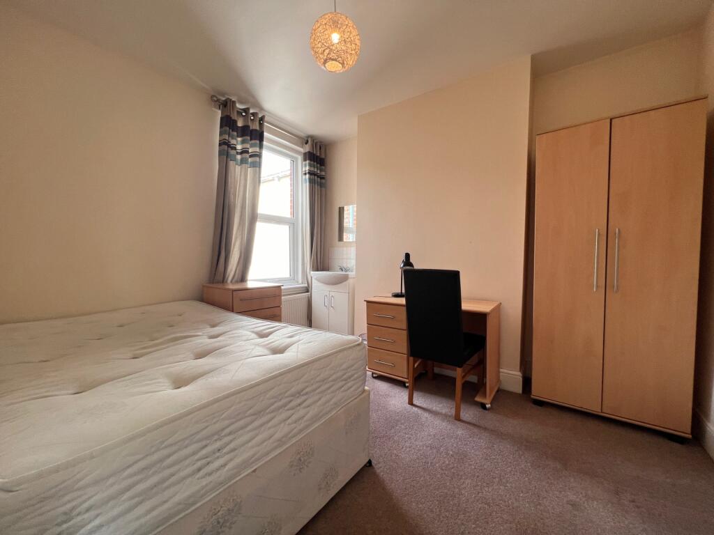 A bright and inviting double bedroom featuring ...