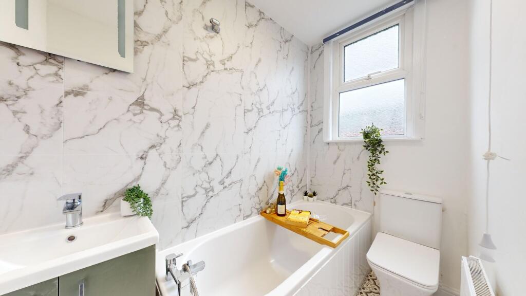 This beautifully designed bathroom features ele...