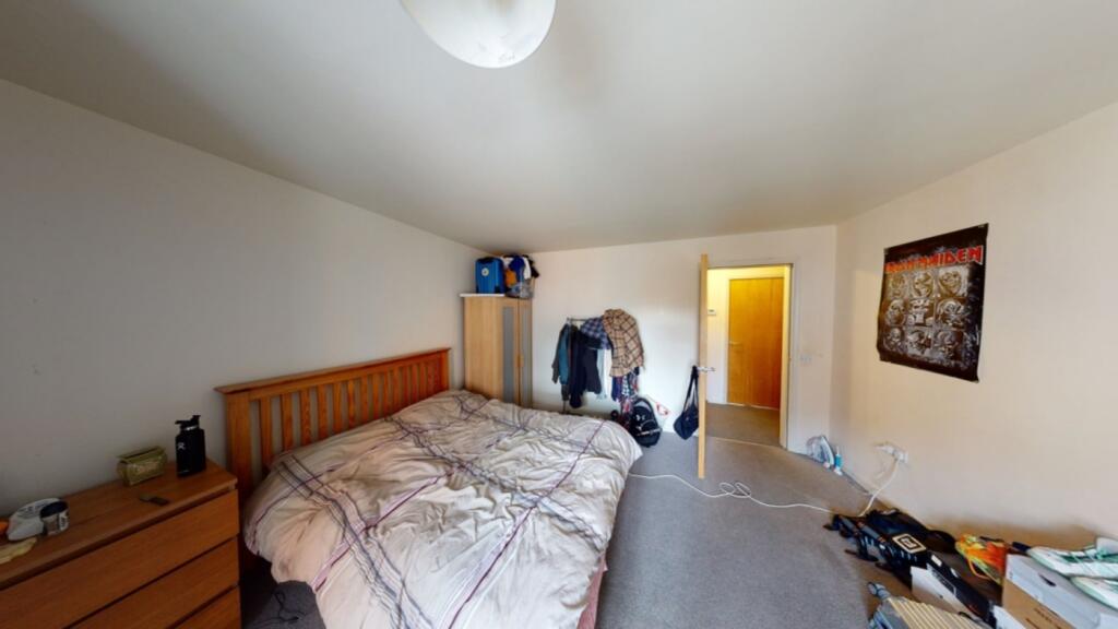 A spacious double bedroom with ample room for s...