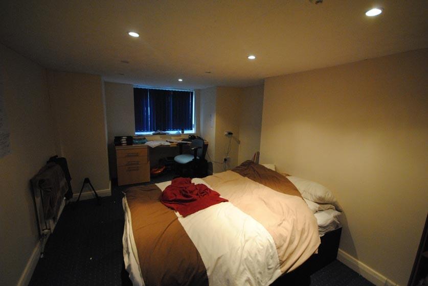 A comfortable bedroom featuring a double bed wi...