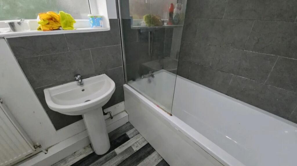 A modern bathroom featuring a stylish bathtub a...