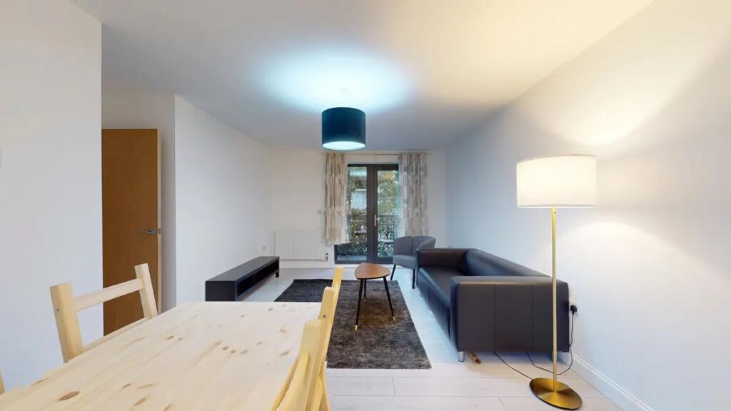 Bright and modern living room featuring a sleek...