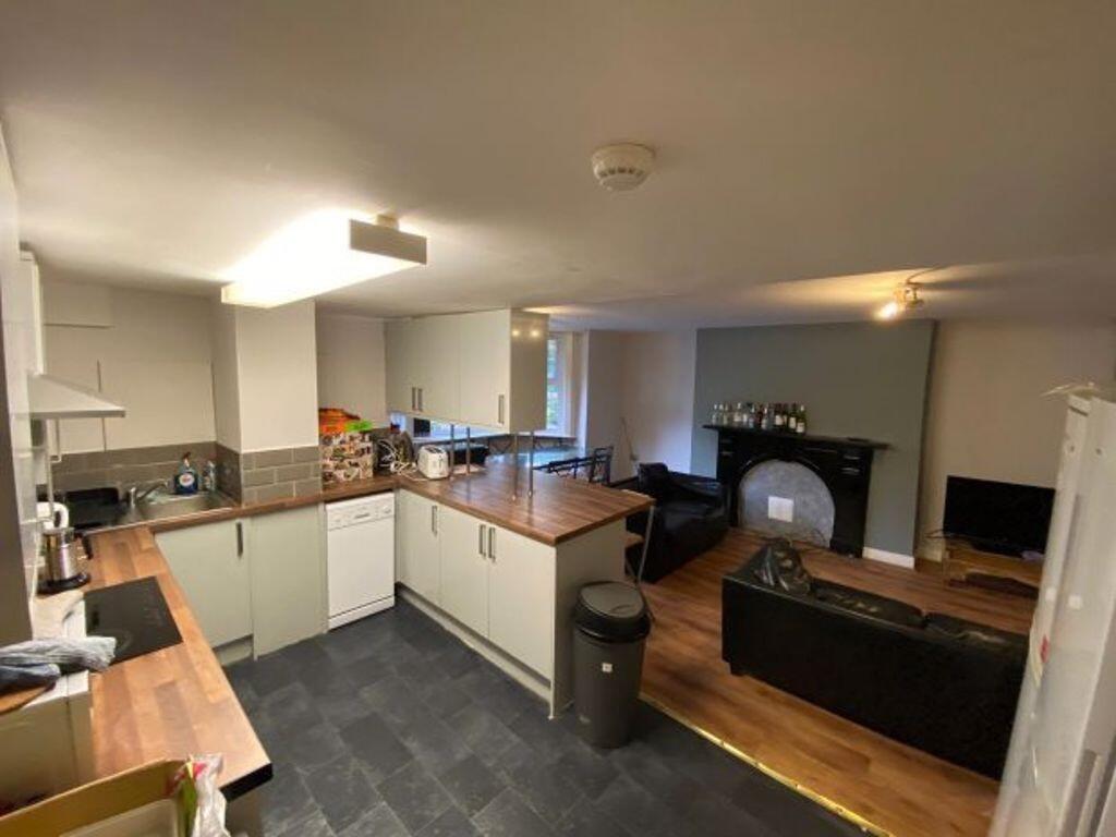 A modern open-plan living area featuring a well...