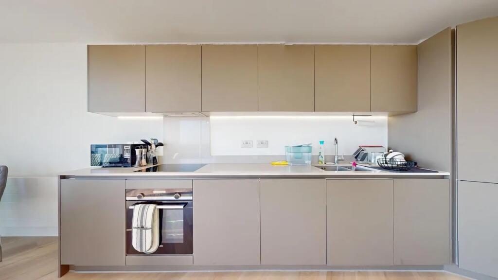 A modern and sleek kitchen featuring clean line...