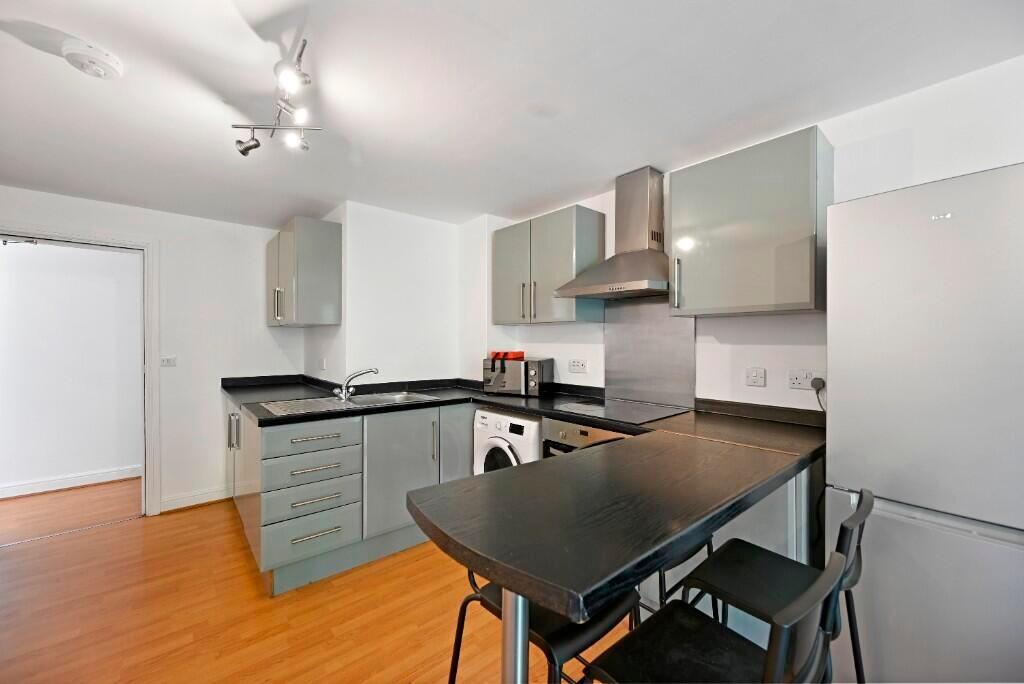 Bright, modern kitchen featuring sleek cabinetr...