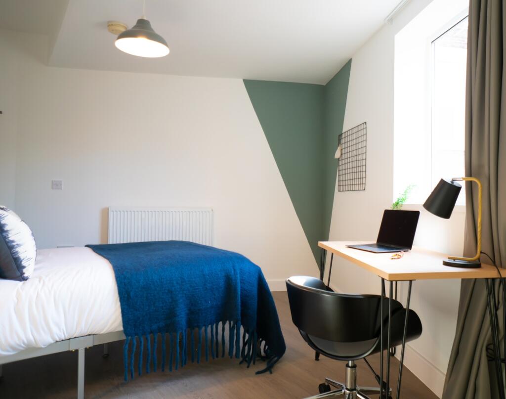 A bright and inviting double bedroom featuring ...