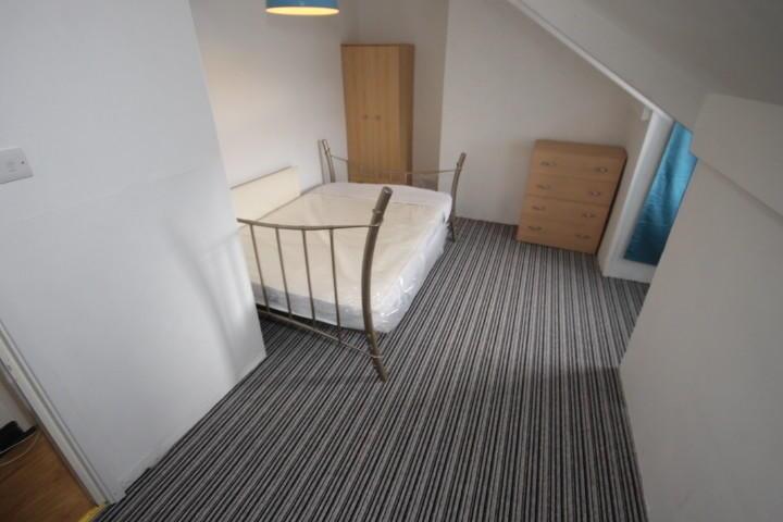 A clean and simple double bedroom featuring a m...