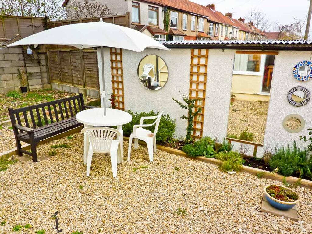 A charming garden space featuring a round table...