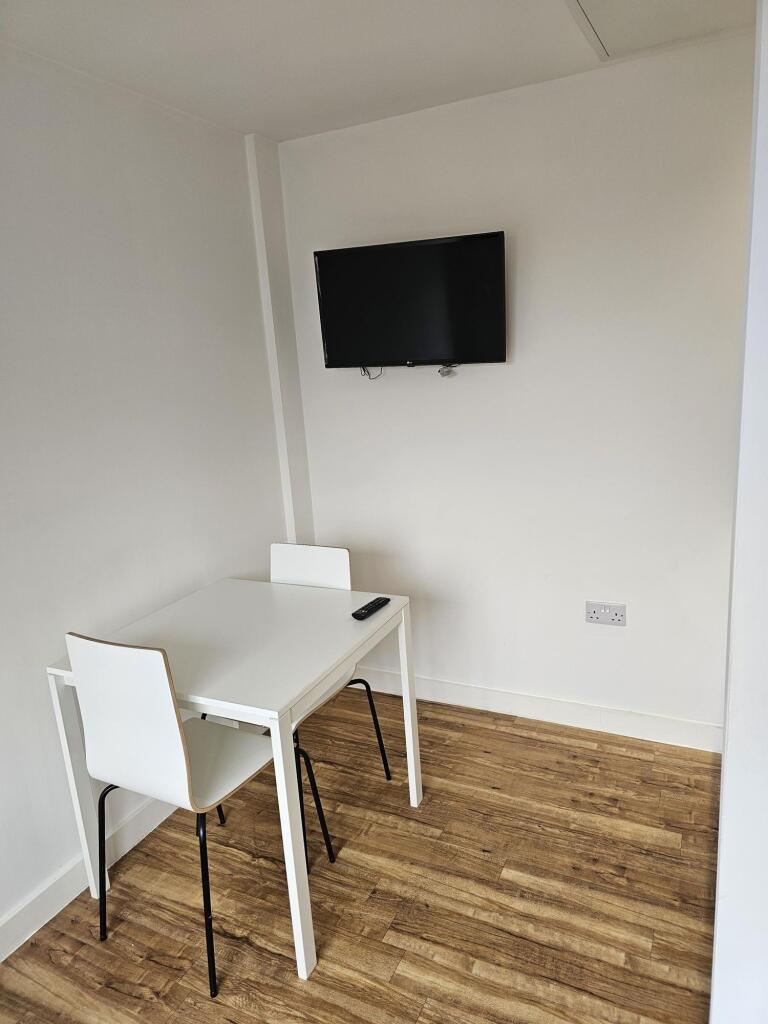 A bright and clean communal workspace featuring...