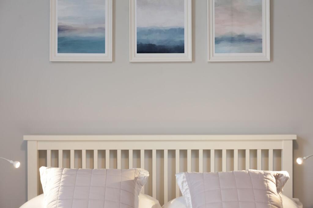 Bright and inviting double bedroom with a white...