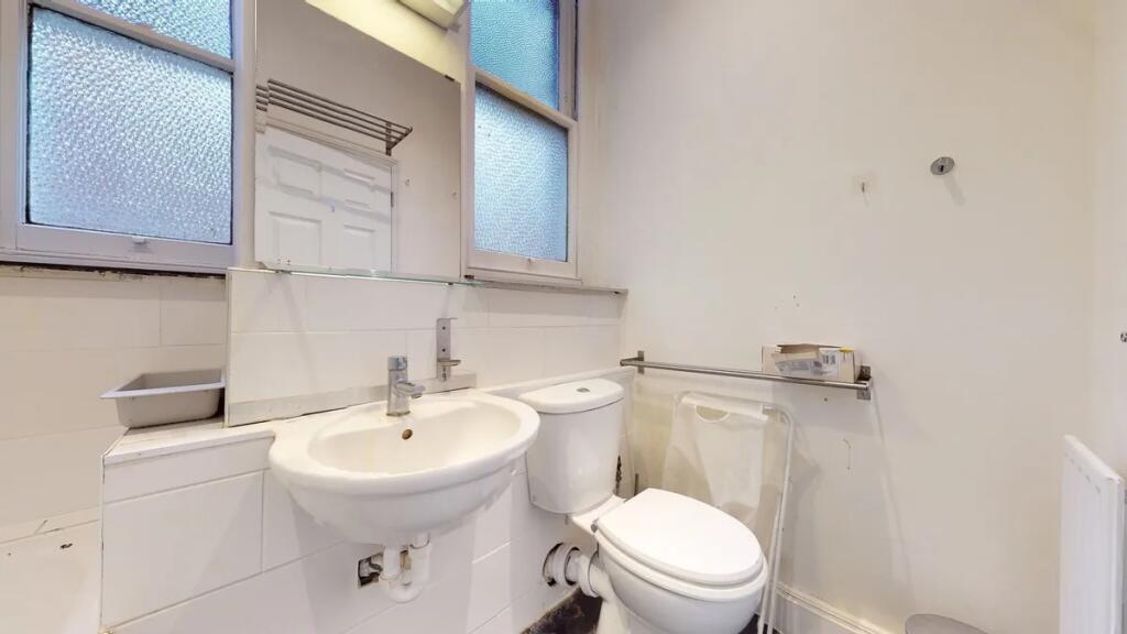 A compact and clean bathroom featuring a white ...