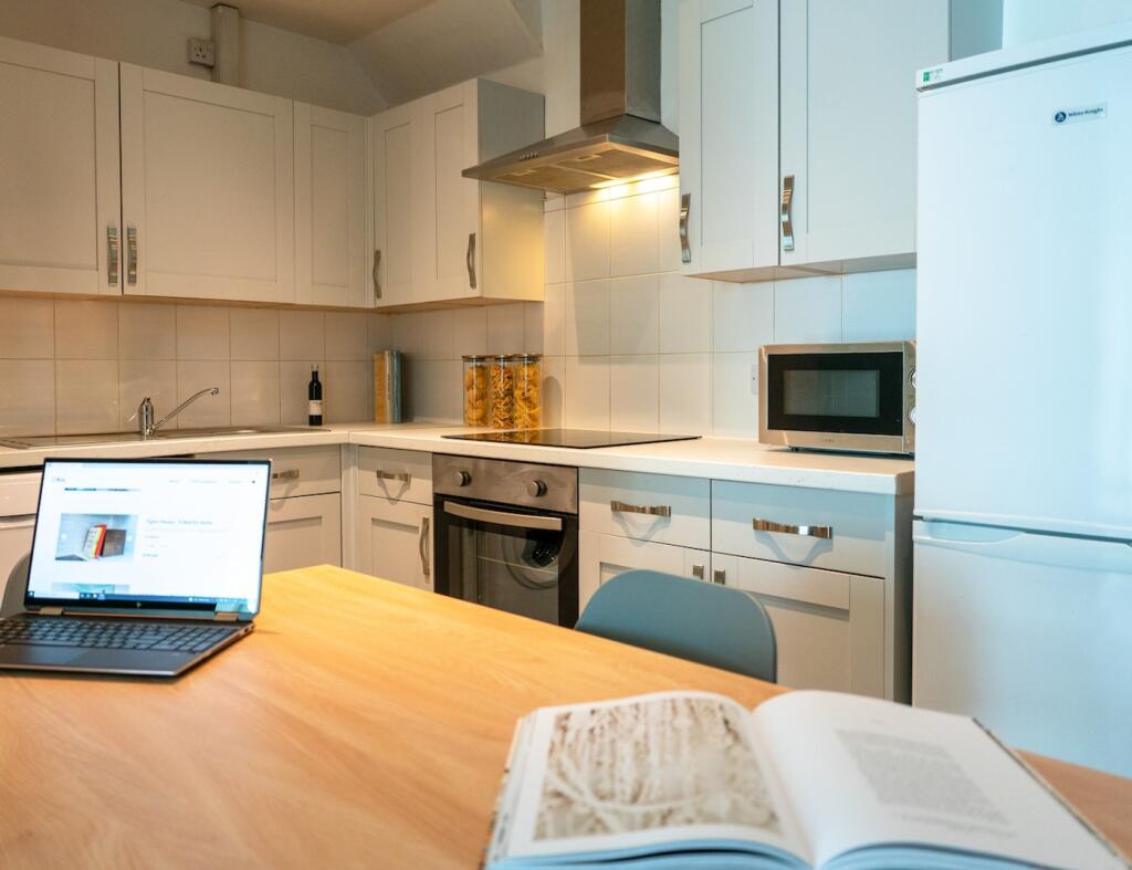 A bright and tidy kitchenette with modern appli...