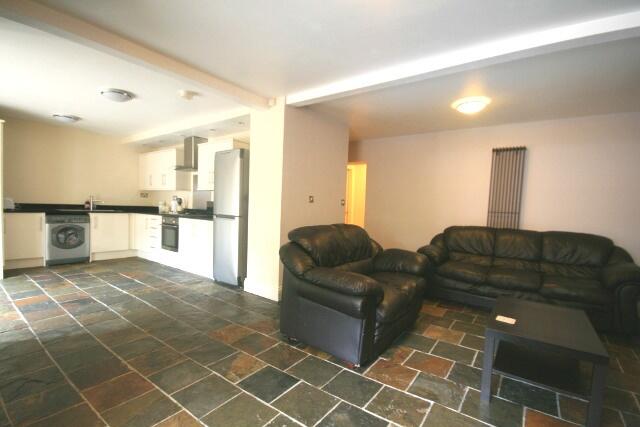 A spacious, modern living room featuring comfor...
