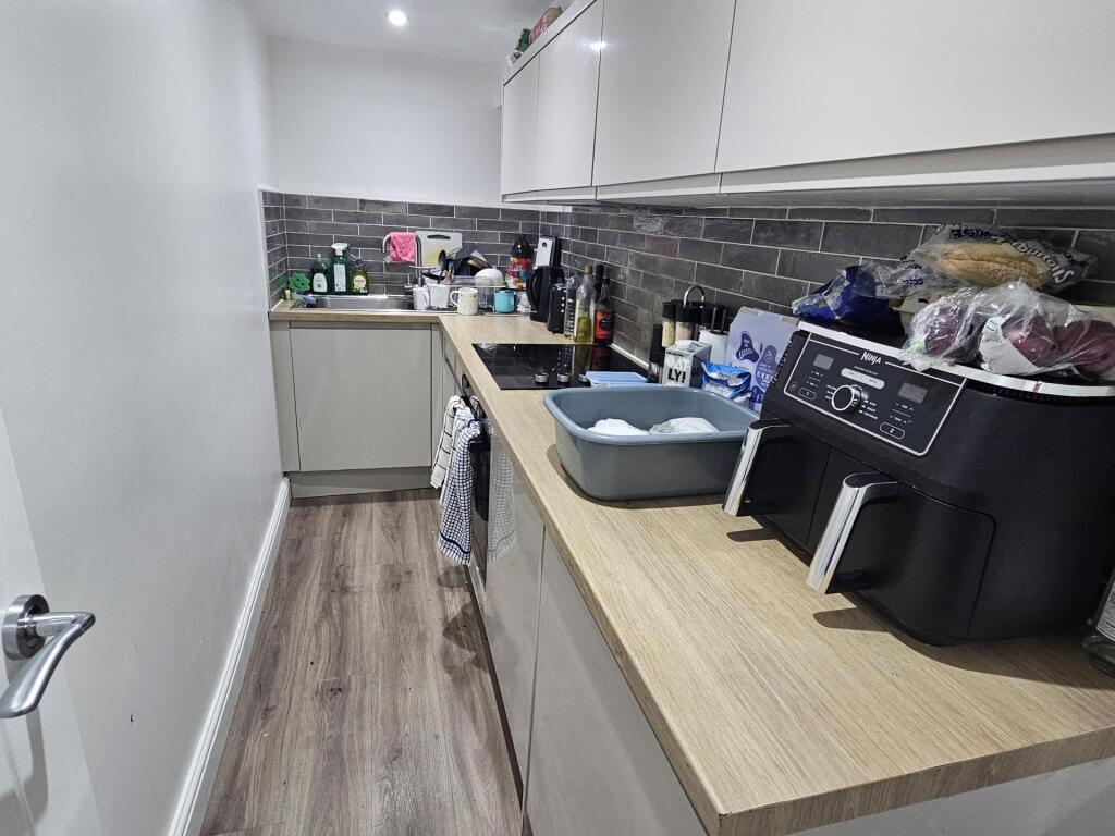 A modern kitchen area featuring a functional la...