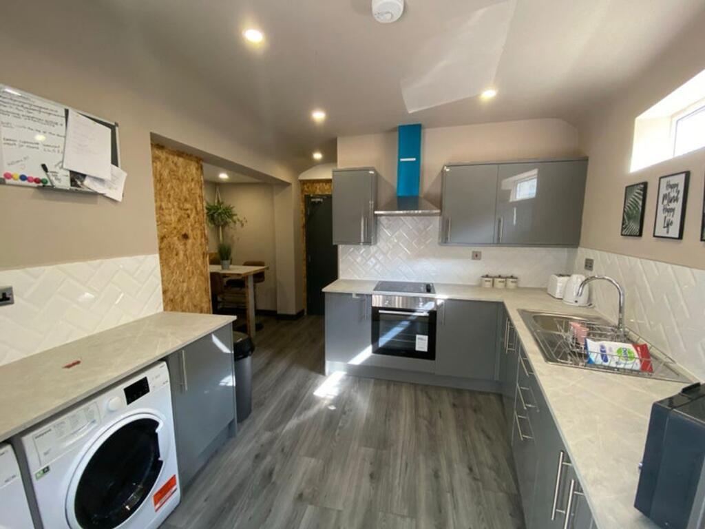 Modern kitchen featuring sleek cabinetry and am...