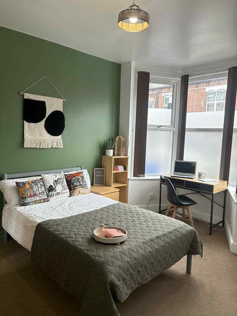 A stylish double bedroom featuring a cozy doubl...