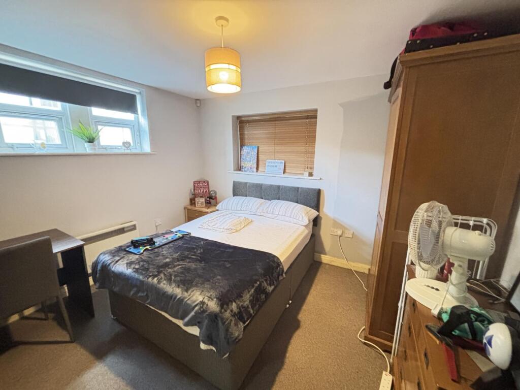 A neatly maintained bedroom featuring a double ...