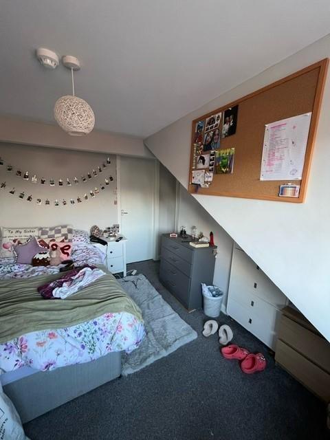 Cozy double bedroom with a comfortable bed, dec...