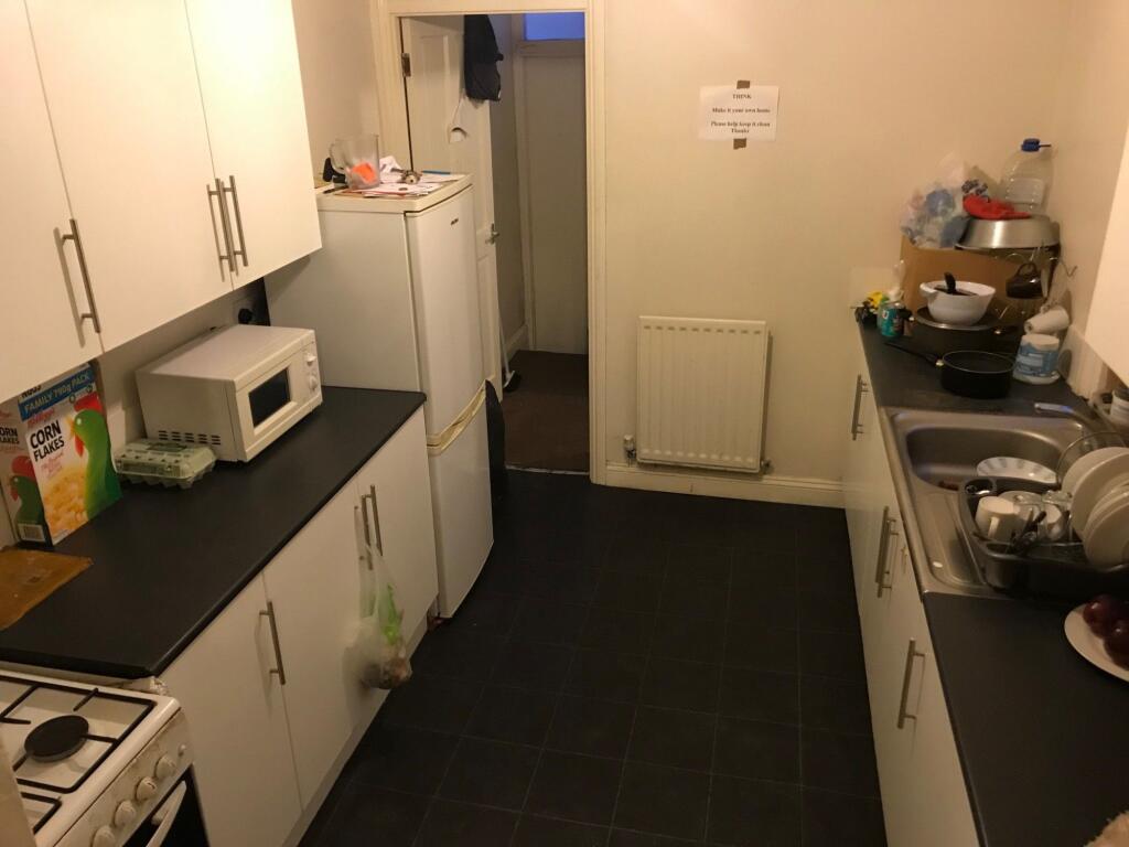A compact, functional kitchen with white cabine...
