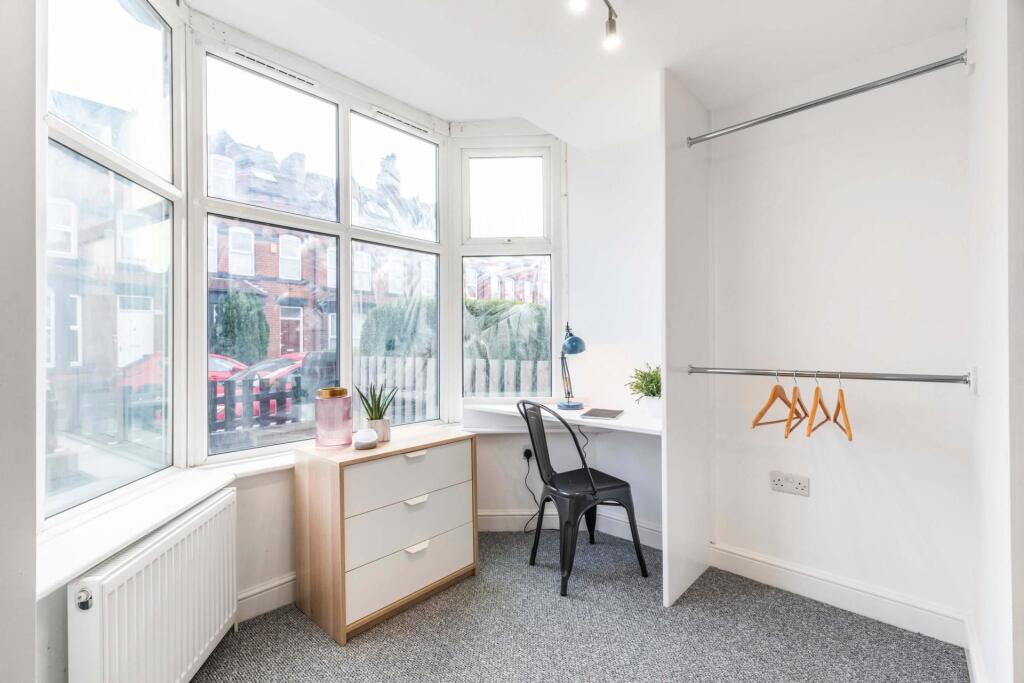 Bright bedroom with a large bay window letting ...