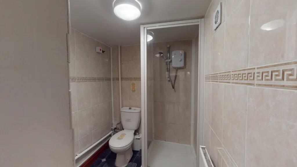 A modern bathroom featuring a clean shower and ...