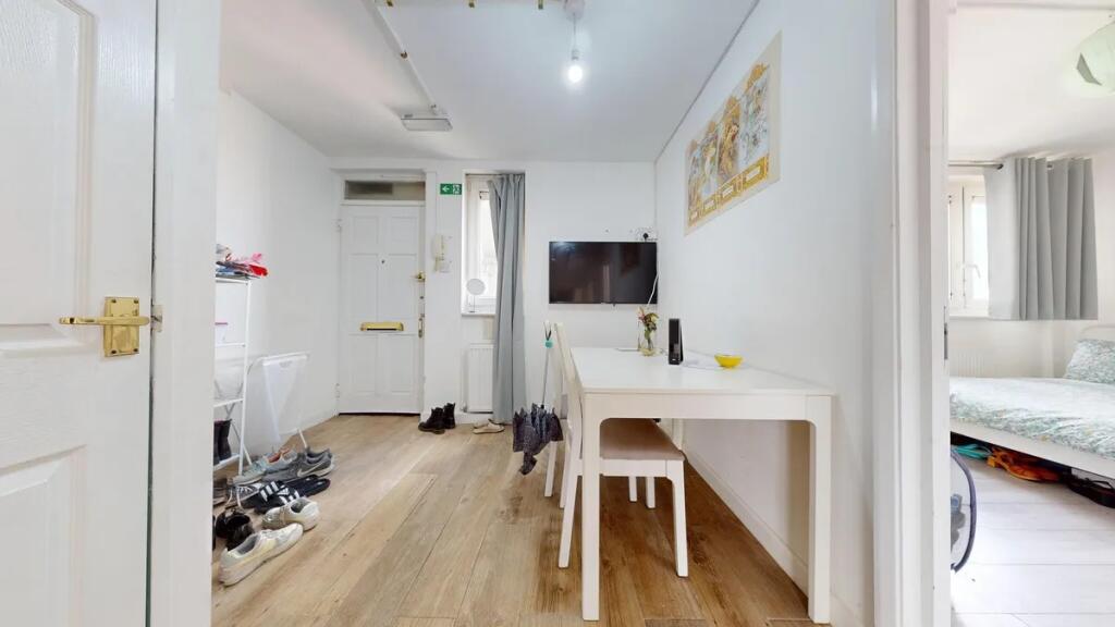 Bright and tidy hallway with wood-effect floori...