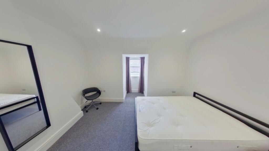 A spacious and clean double bedroom with ample ...