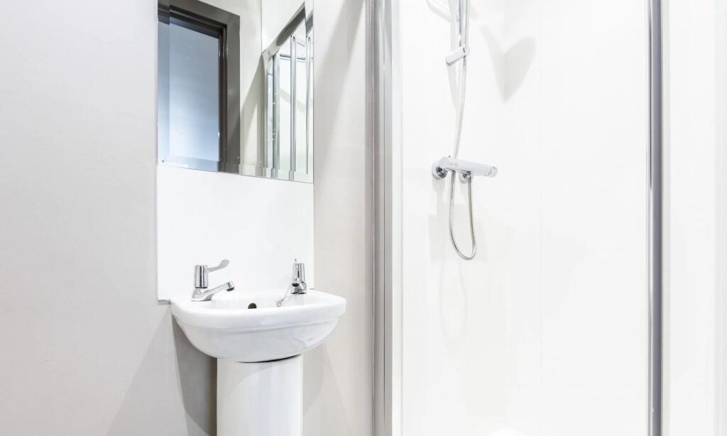 Bright and neat bathroom featuring a modern ped...