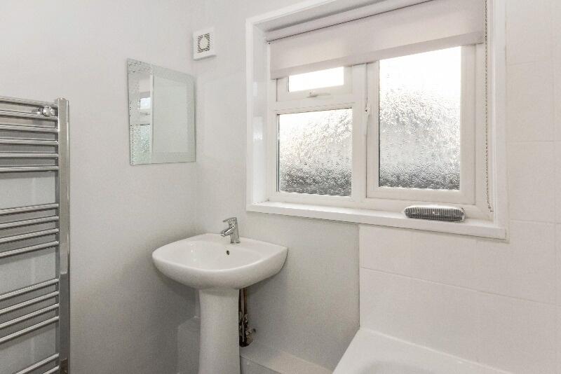 A bright and clean bathroom featuring a modern ...