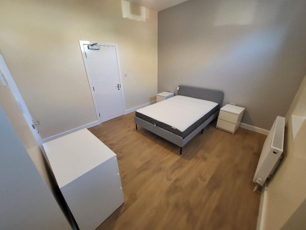 This inviting double bedroom features ample spa...