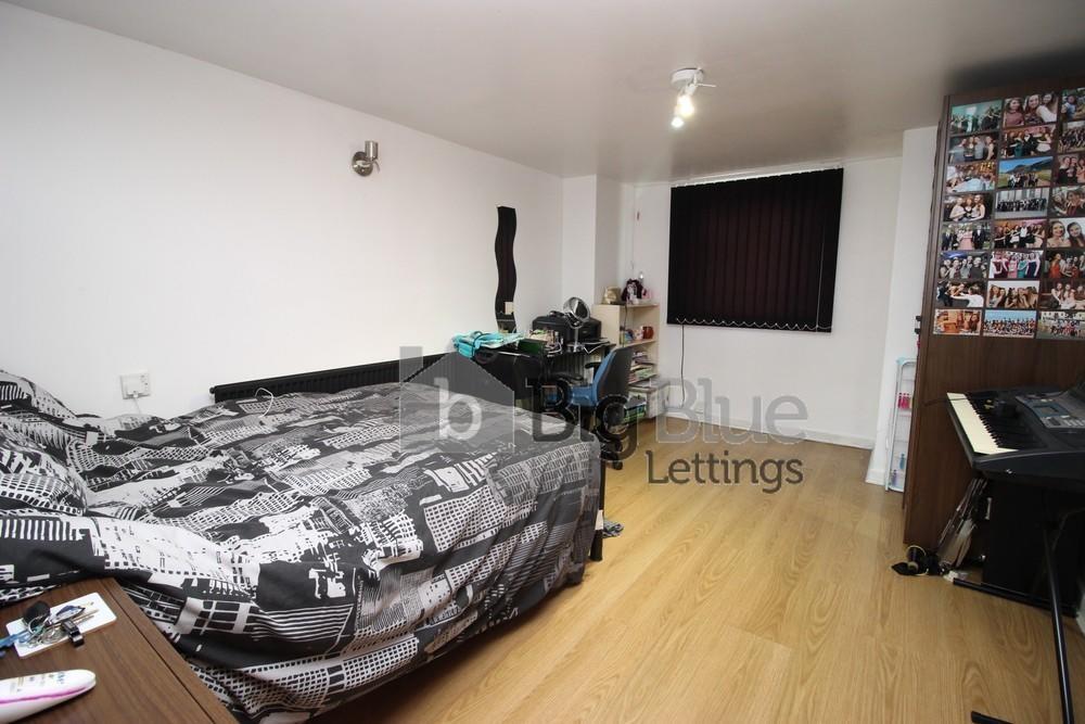 Cozy single bedroom featuring a comfortable bed...