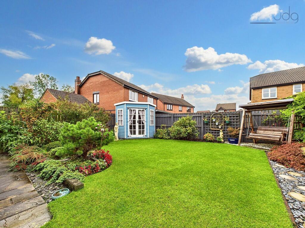 Northwest Garden with summer house and a mixture of lawn and flags