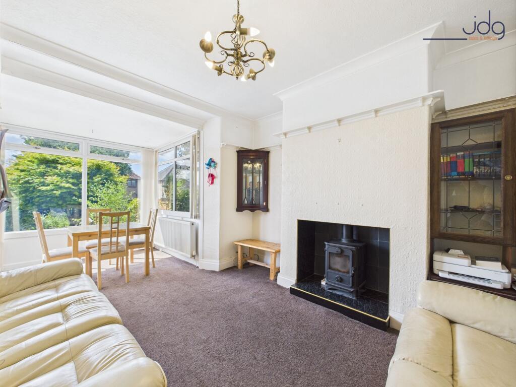 Living Room with extended sunroom and wood-burning stove