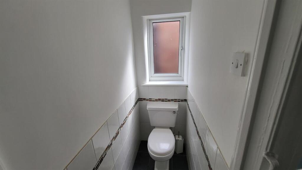 A clean and functional bathroom with natural li...