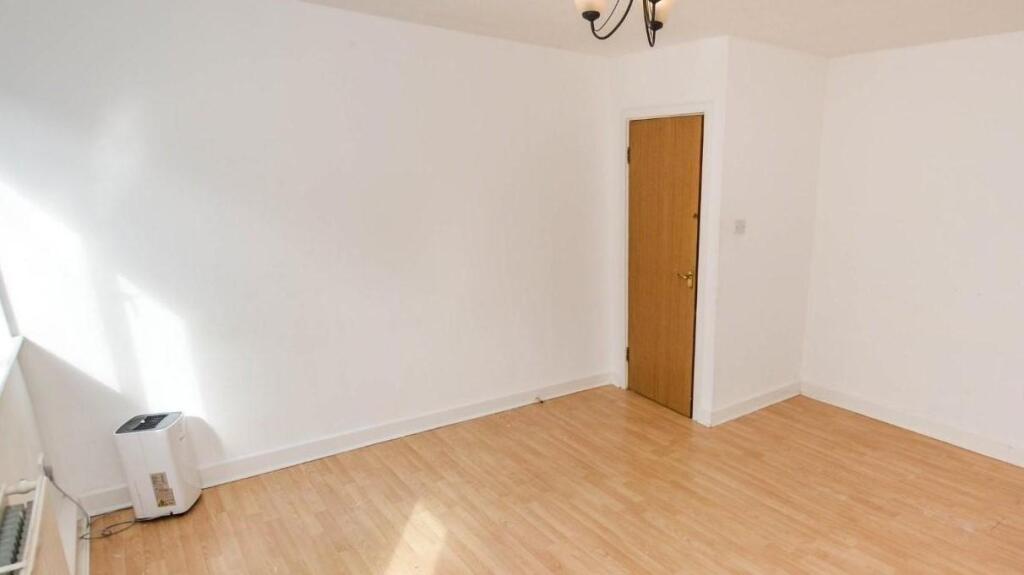 Bright room with natural light and clean wooden...