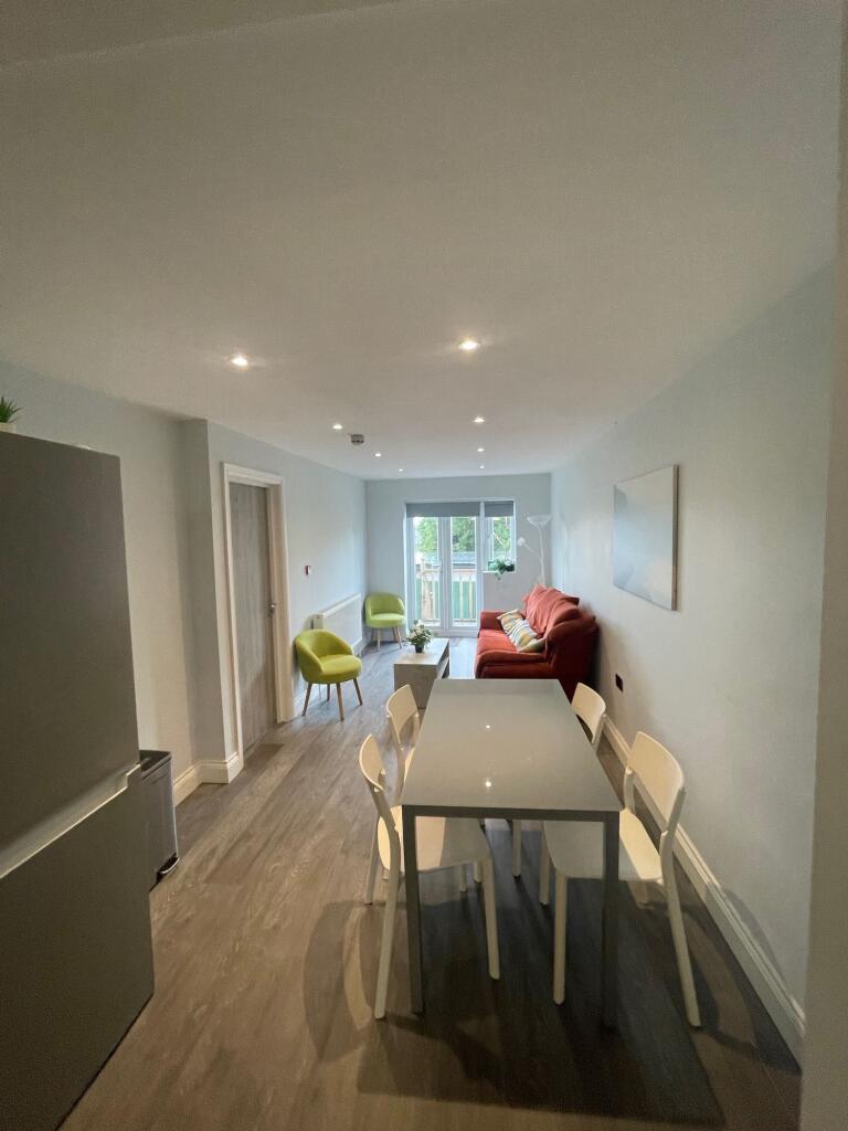 A modern living and dining area featuring a com...