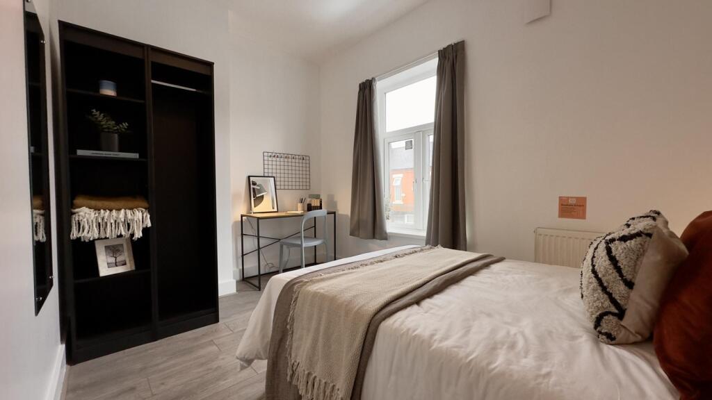 A bright and inviting double bedroom featuring ...