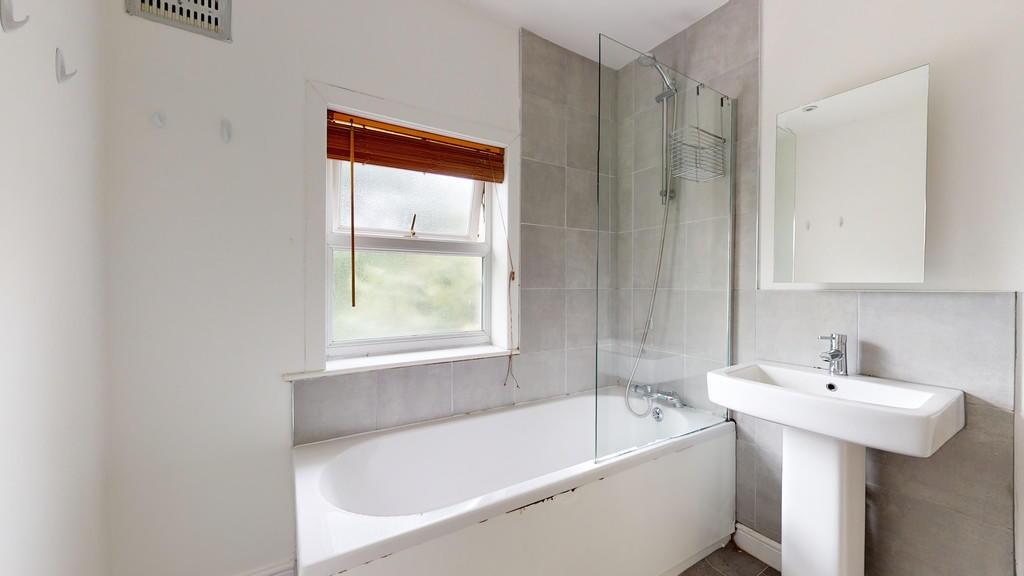 A bright and modern bathroom featuring a white ...