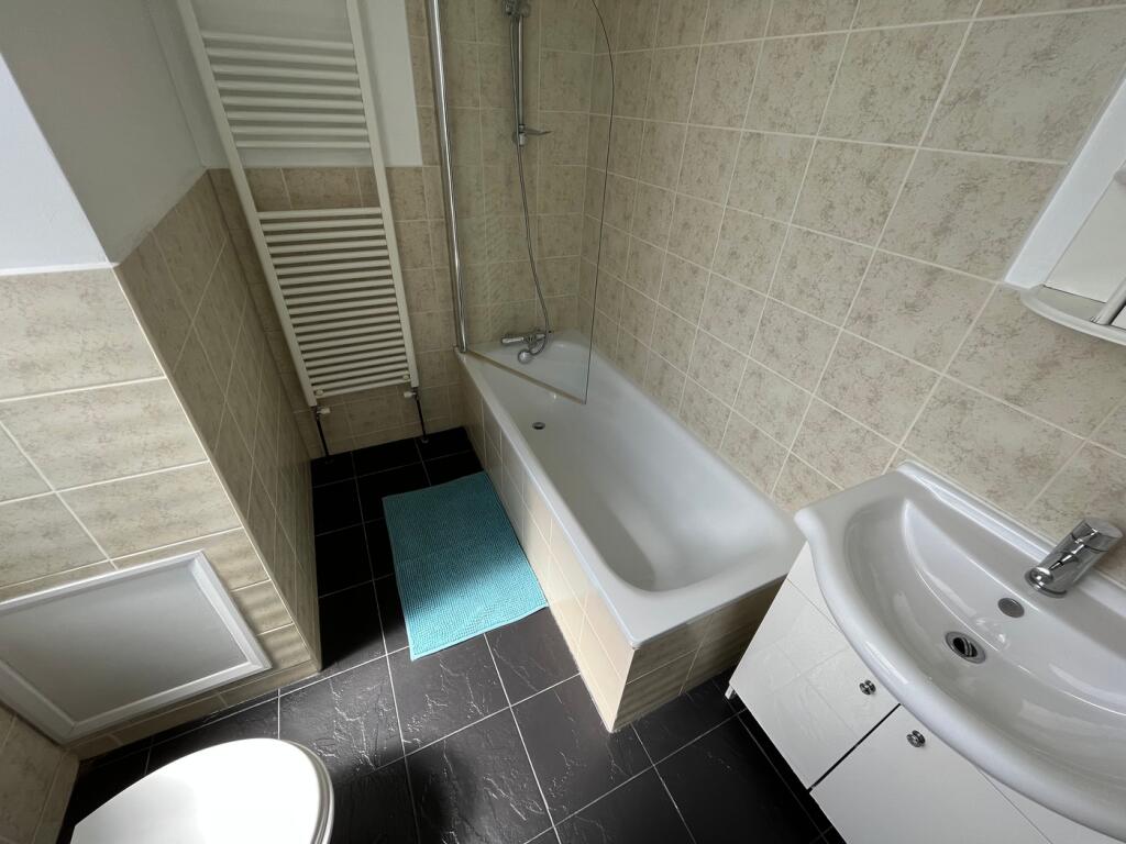 This well-maintained bathroom features a clean ...