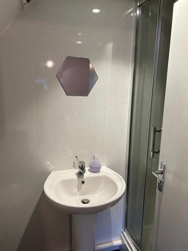 A clean and modern bathroom with a white pedest...