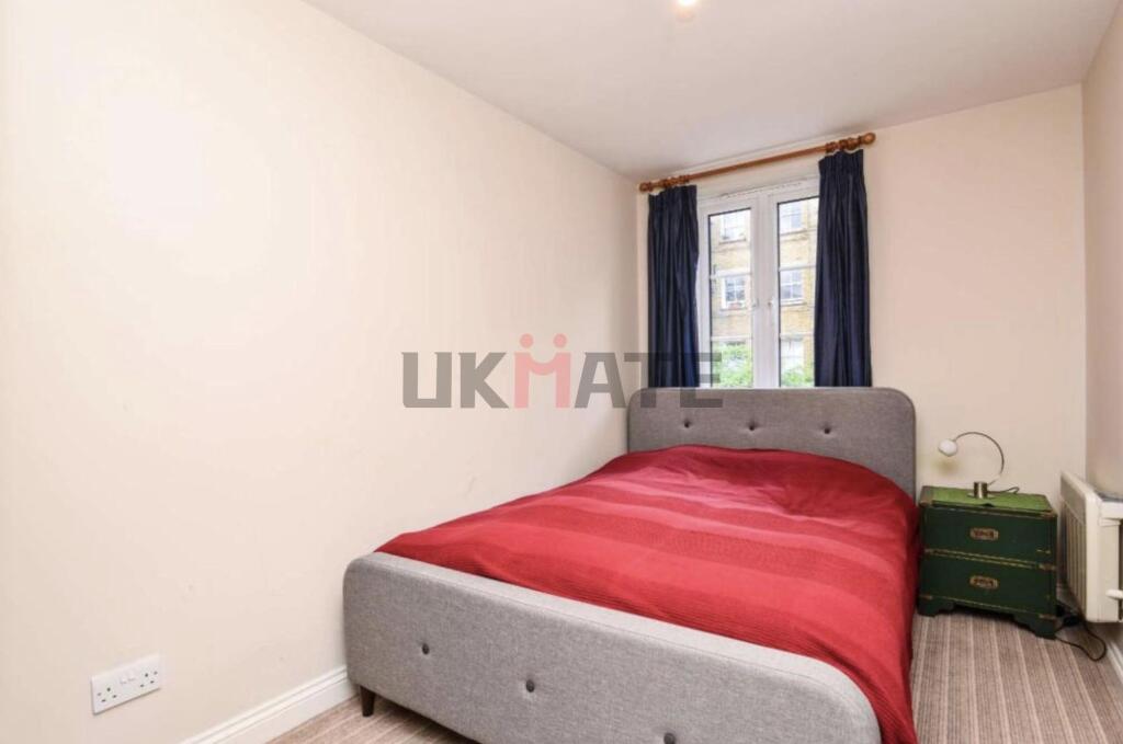 A well-lit, inviting double bedroom featuring a...