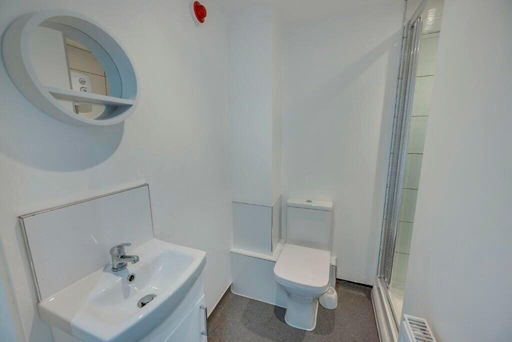 Bright and clean bathroom featuring a modern si...