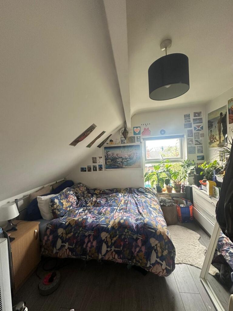 Cozy double bedroom featuring a vibrant floral ...