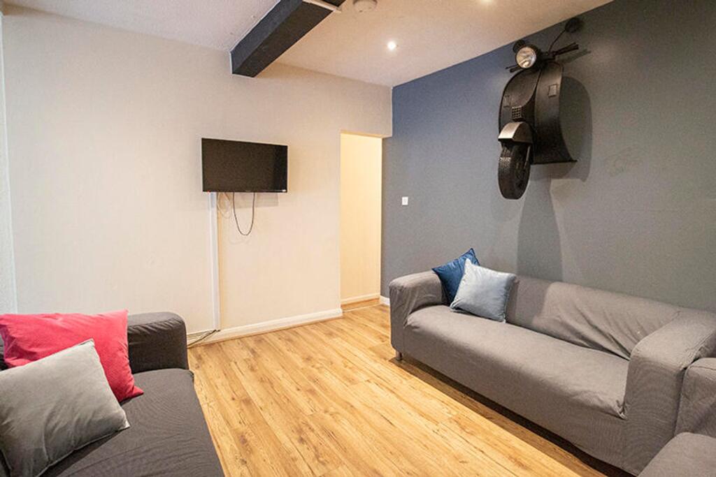 A cozy living room featuring comfortable grey s...