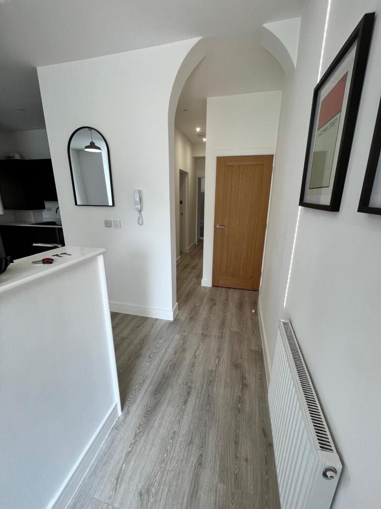 Bright modern hallway with light wood-effect fl...