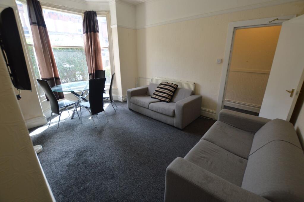 A cozy living room featuring two grey sofas and...