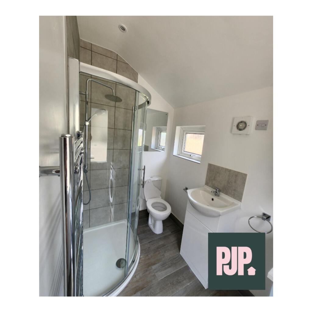 A bright and modern bathroom featuring a spacio...