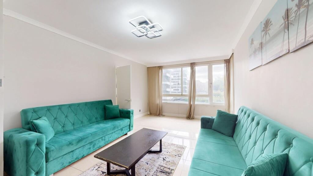 Bright and spacious living room with large wind...