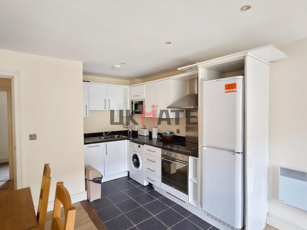 Modern and neatly organized kitchen with white ...